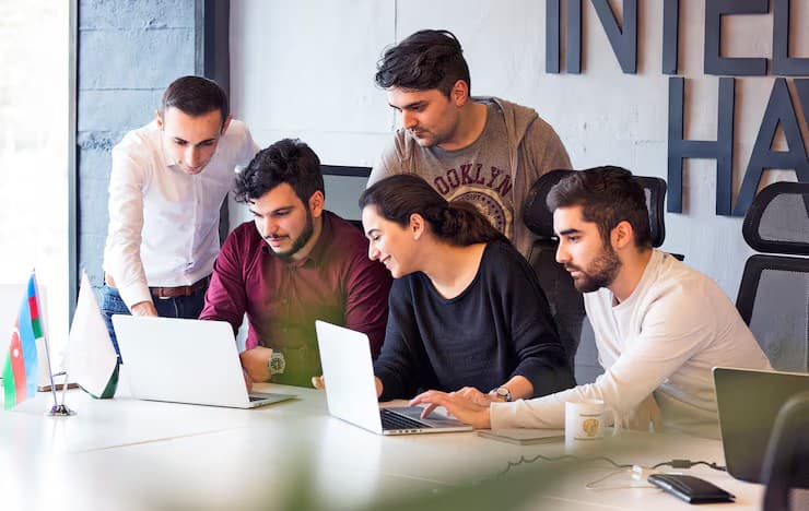 Developers collaborating on laptops